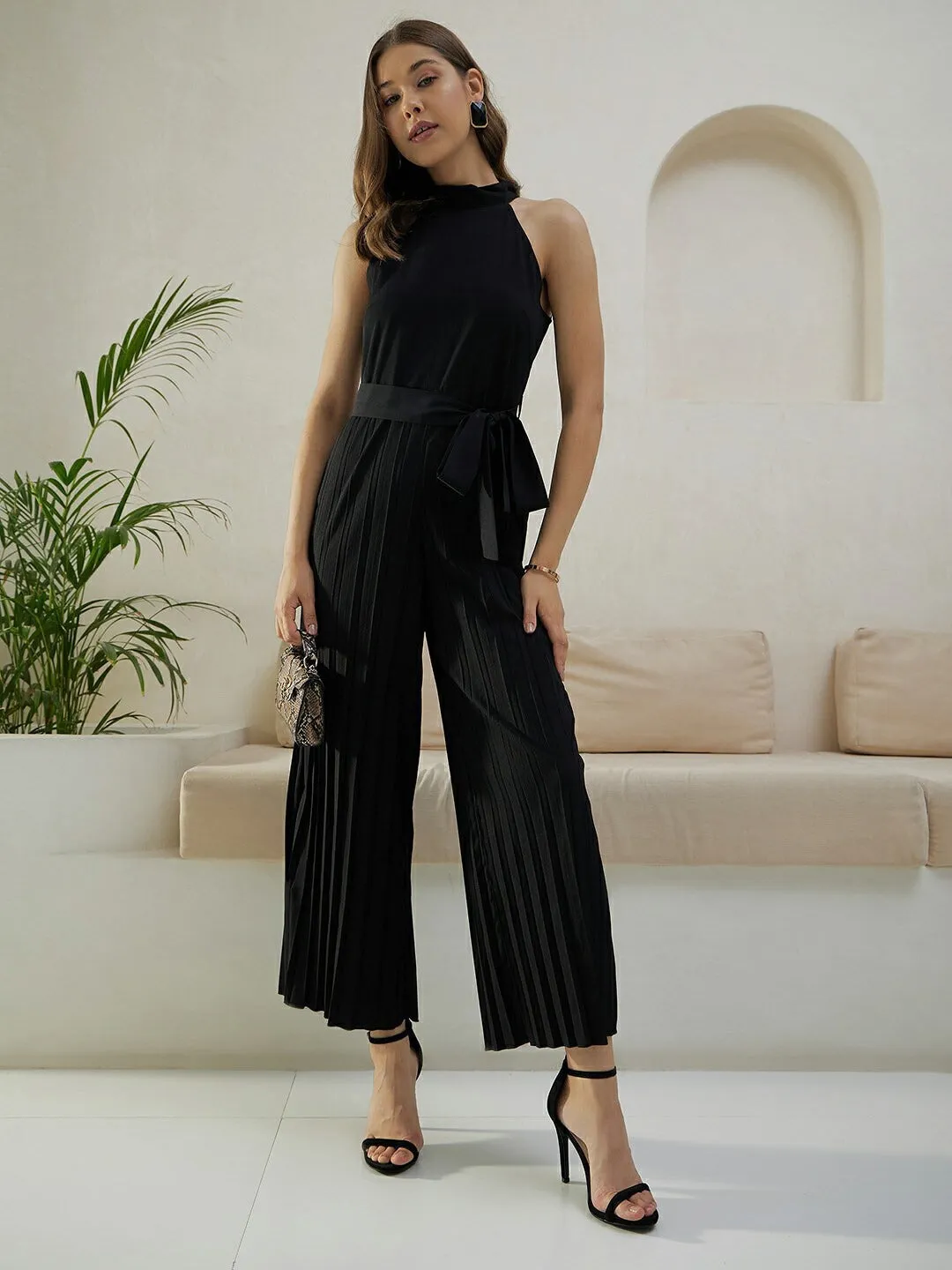 Berrylush Women Solid Black Halter Neck Sleeveless Waist Tie-Up Pleated Culotte Jumpsuit